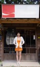 A woman standing in front of a coca cola store.